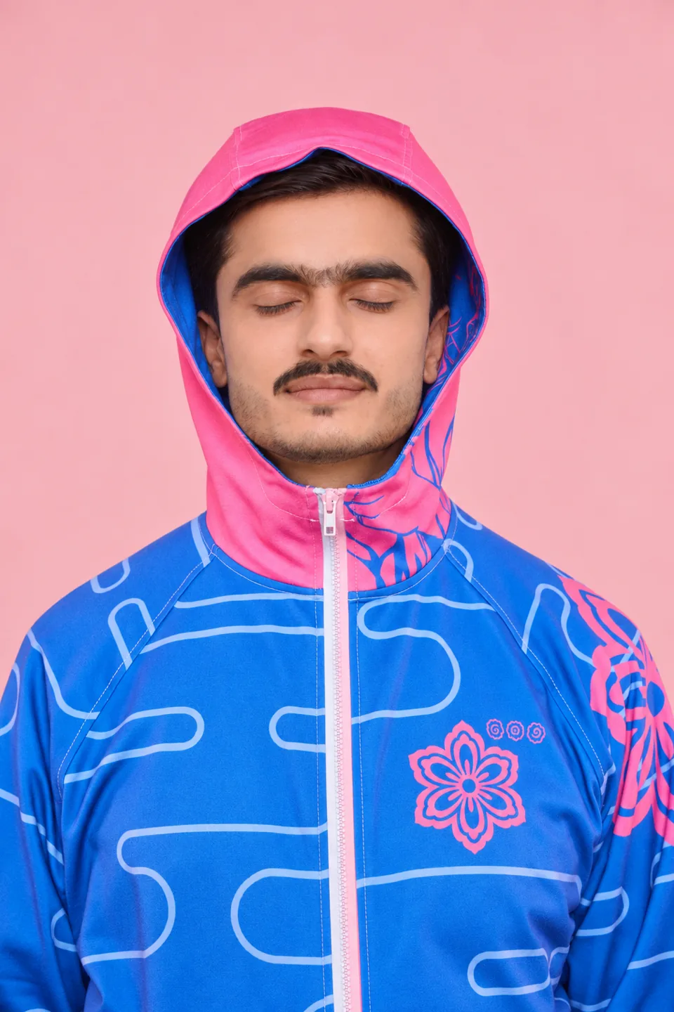 Man in a pink and blue printed hoodie